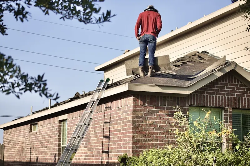 Professional roofer working on a residential roof in Cornog